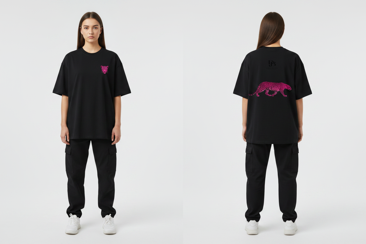 Female model wearing the DJB Cheetah Unisex Oversized Drop Shoulder T-Shirt, showing the front and back print